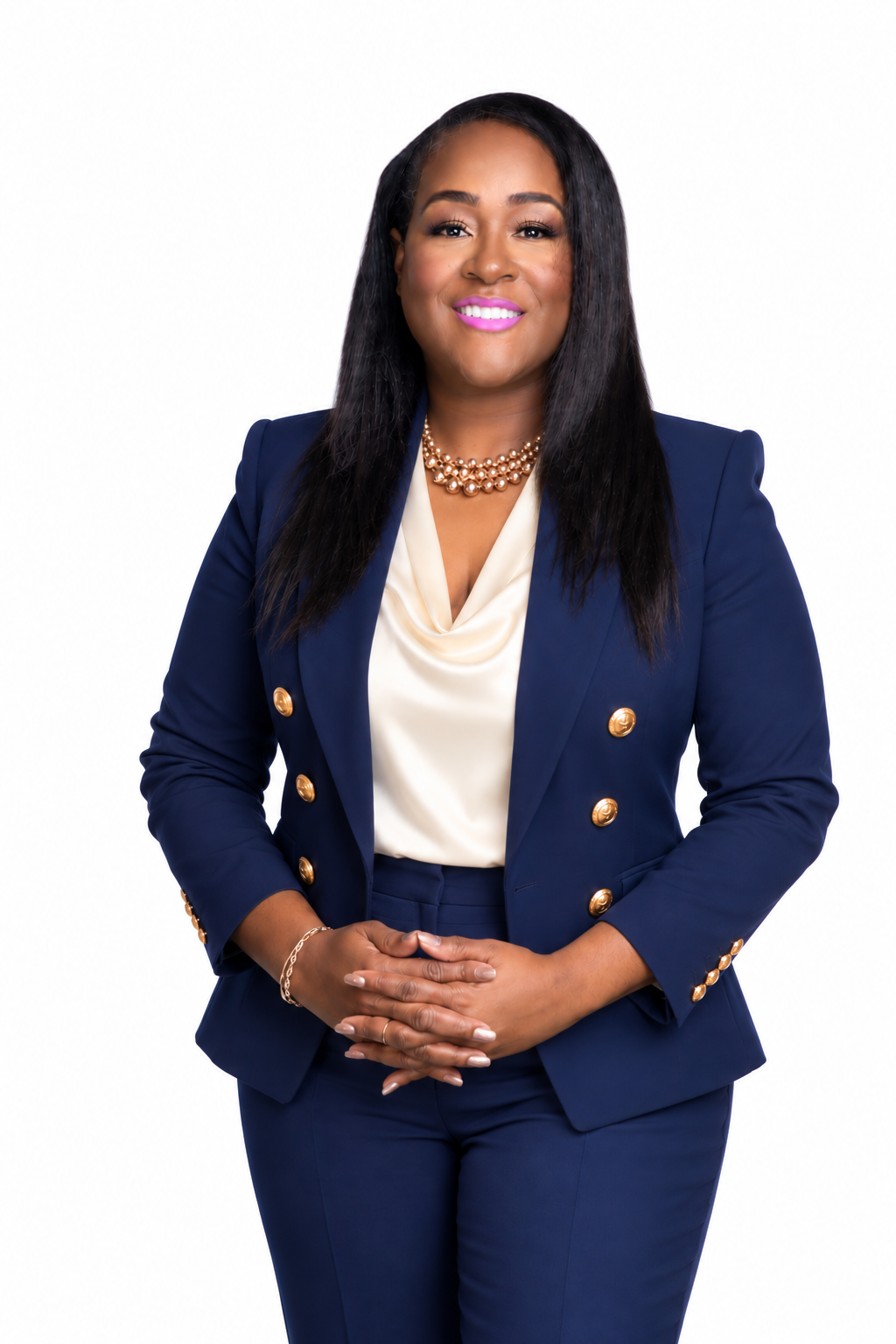 Kenya Avery in a navy suit with a cream blouse and gold accents